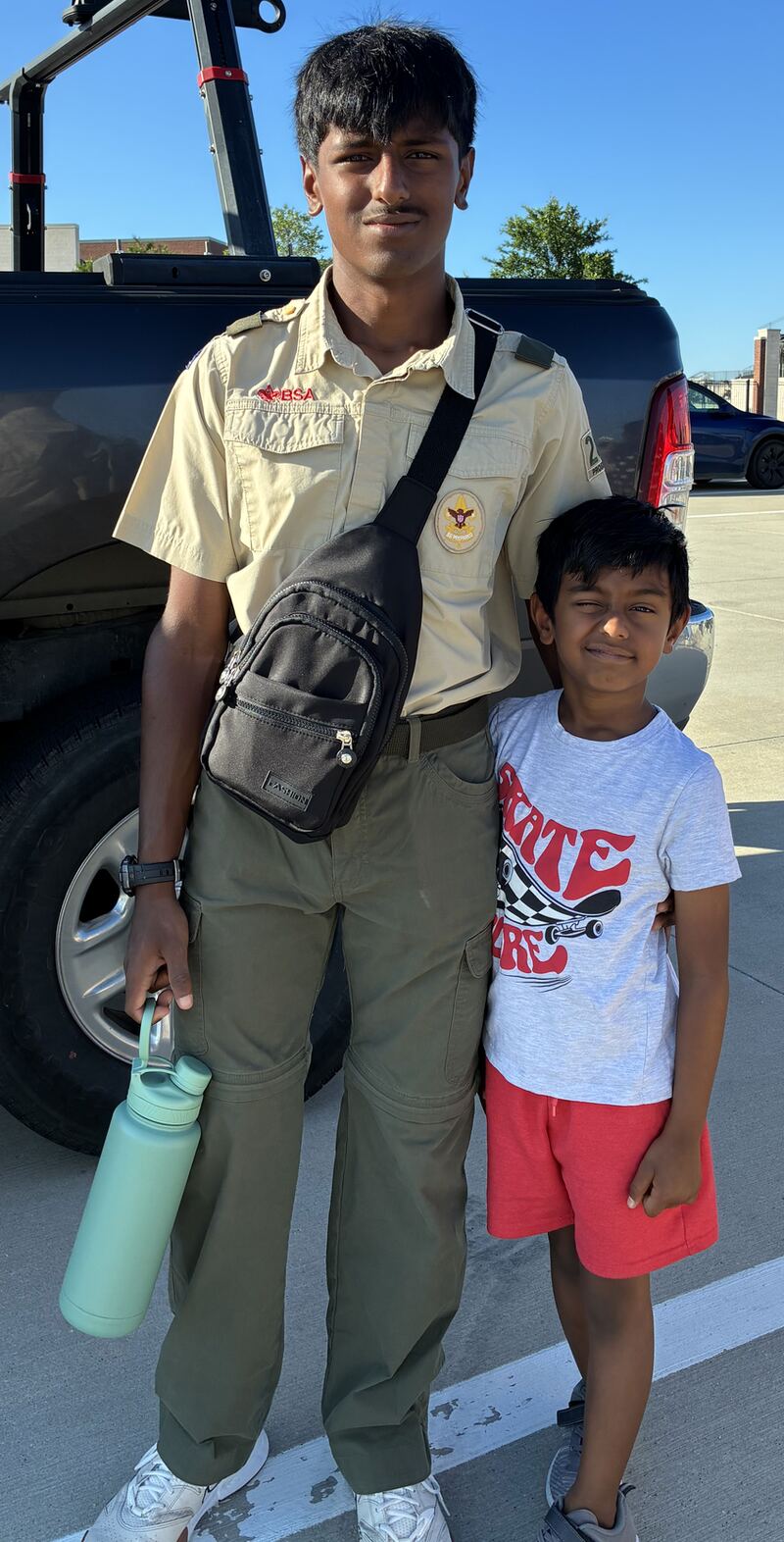Sanjeeva in his Scout uniform standing with his younger brother Nidhulan